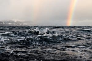 rainbow on a rough ocean