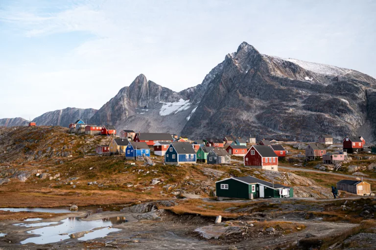 colorful houses with mountains in the background in east greenland kumiuut